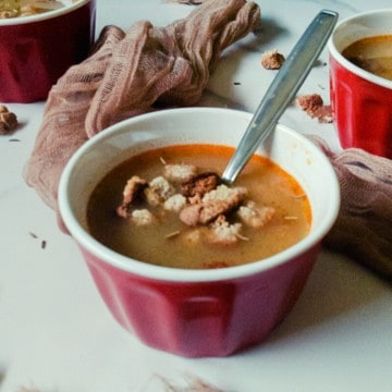 hungarian caraway soup in a red bowl